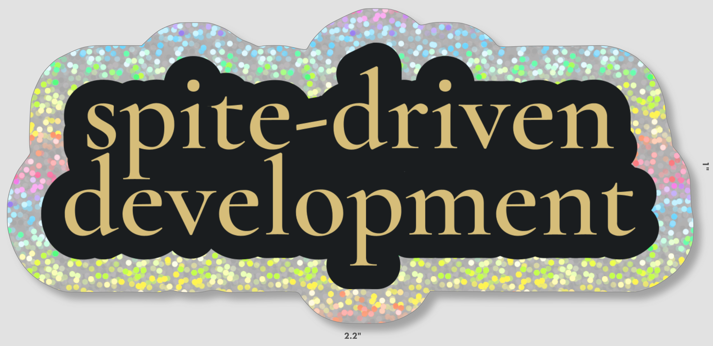 spite-driven development in gold serif font on black outline with larger sparkly outline. Sticker is 1 by 2.2 inches